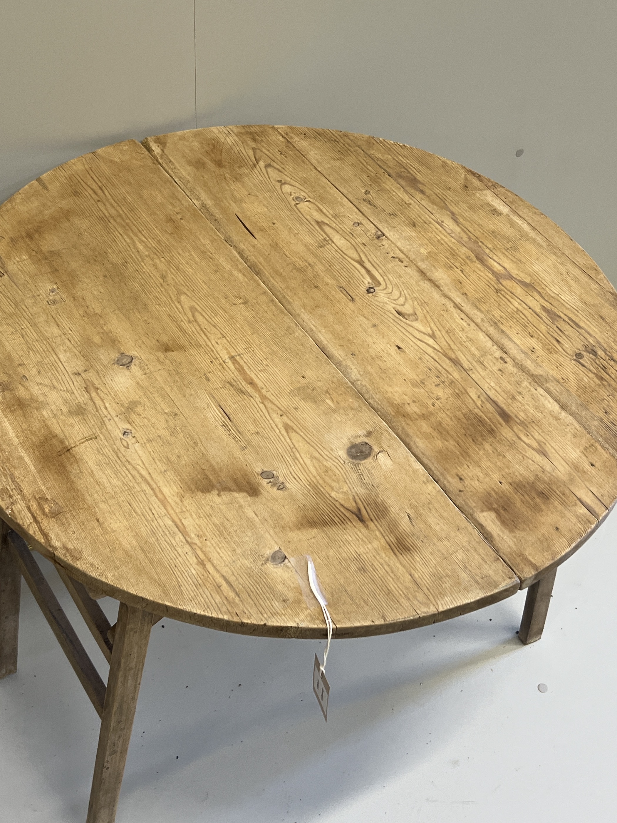 A 19th century French circular pine folding occasional table, diameter 75cm, height 68cm